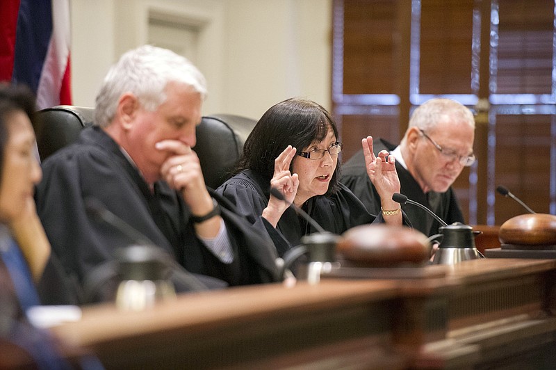 
              FILE- In this Aug. 27, 2015, file photo, Chief Justice Mark Recktenwald, from left, Associate Justice Sabrina S. McKenna, and Associate Justice Michael Wilsonas preside as oral arguments at the Hawaii State Supreme Court. The case involves building one of the world's largest telescopes on Mauna Kea. The Hawaii Supreme Court said Tuesday, Nov. 17, that it is temporarily suspending a permit that allows the giant telescope to be built on a mountain many Native Hawaiians consider sacred. (Craig T. Kojima/Honolulu Star-Advertiser via AP, Pool, File)
            