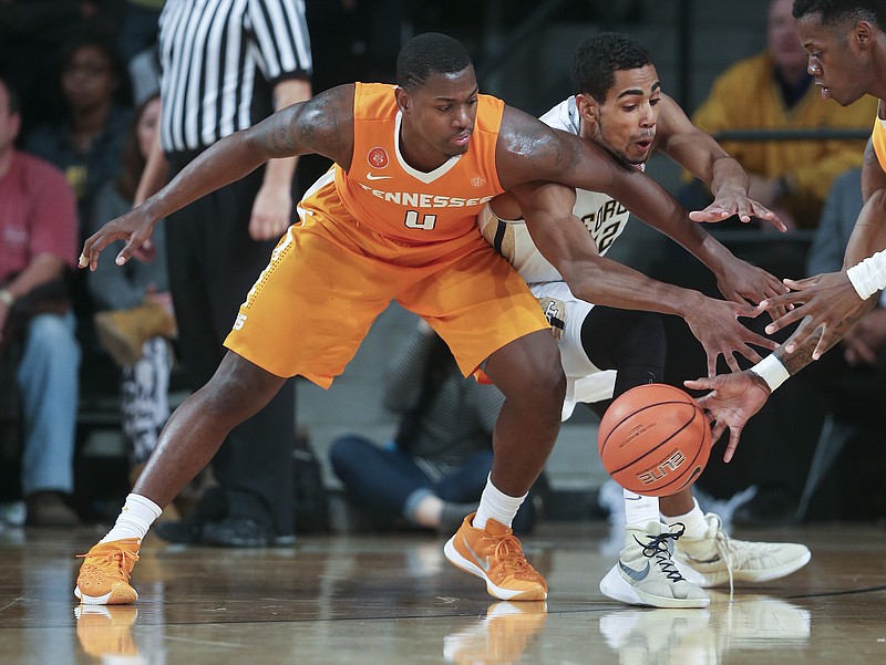 Tennessee Armani Moore (4) and Devon Baulkman, right, battle for the ball withGeorgia Tech forward Quinton Stephens (12) in the second half of an NCAA college basketball game Monday, Nov. 16, 2015, in Atlanta. Georgia Tech won 69-67. 