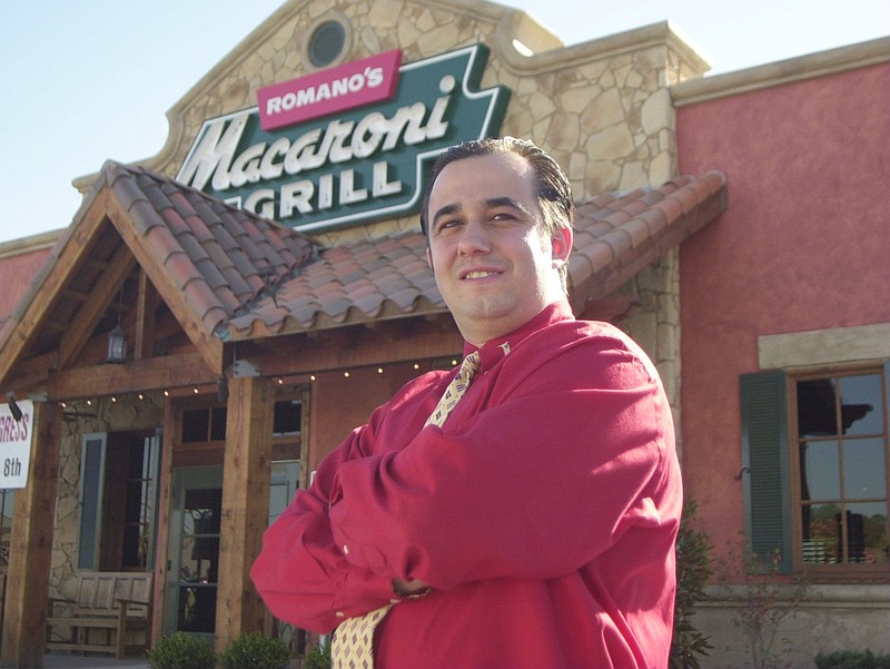 In this file photo, manager Riza Korur makes final preparations for the Nov. 8, 2001, opening of Romano's Macaroni Grill on Gunbarrel Road.