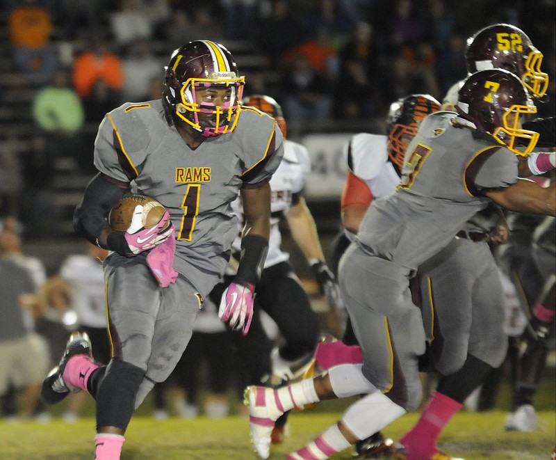 Tyner running back Shannon Spralls heads upfield with blocks from Chaysen Patrick (7) and Jaylon Beeman during a game this season.