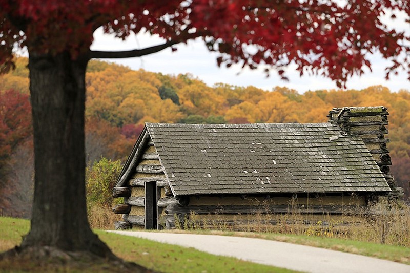 A cabin is seen in view of Autumn foliage on Friday, Oct. 30, 2015, at Valley Forge National Historical Park in Valley Forge, Pa. (AP Photo/Matt Rourke)