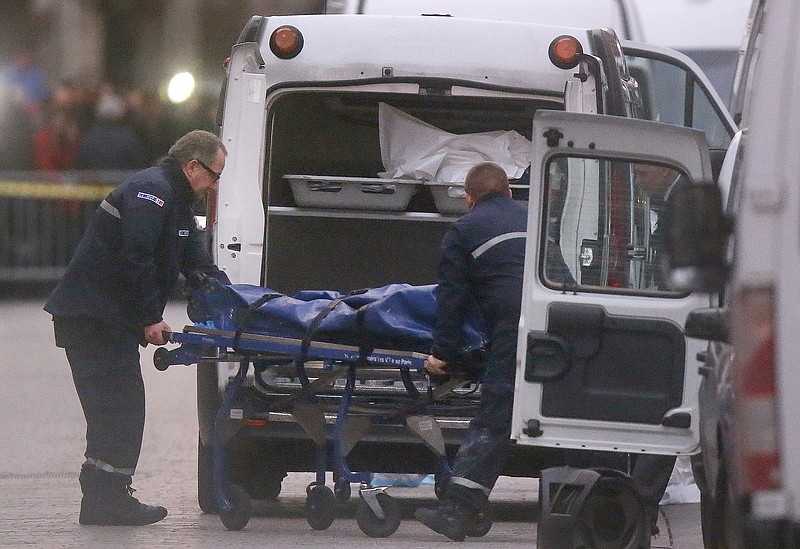 
              Two men carry a  body into a hearse after an intervention of security forces against a group of extremists in Saint-Denis, near Paris, Wednesday, Nov. 18, 2015. A woman wearing an explosive suicide vest blew herself up Wednesday as heavily armed police tried to storm a suburban Paris apartment where the suspected mastermind of last week's attacks was believed to be holed up, police said. (AP Photo/Michel Euler)
            