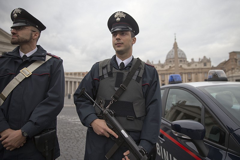 
              Italian Carabinieri officers patrol the area St' Peter's Square, at the Vatican, prior to the start of Pope's weekly general audience,  Wednesday, Nov. 18, 2015. (AP Photo/Andrew Medichini)
            