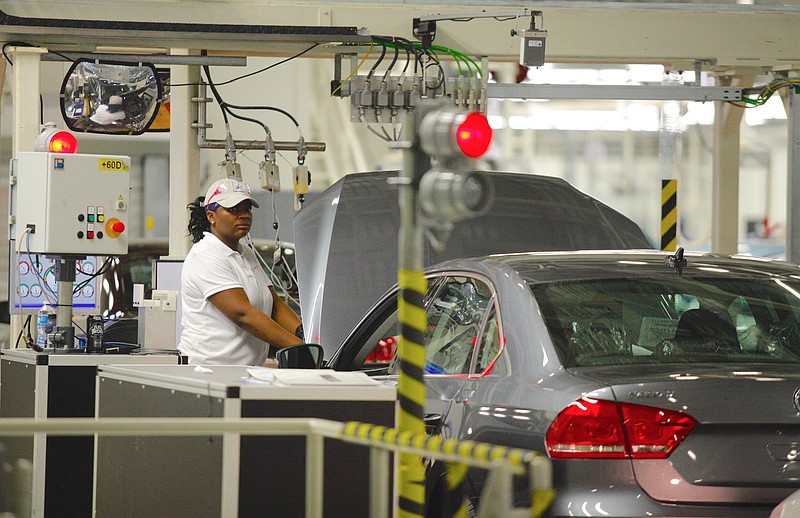 A factory worker performs diagnostics on a Passat before it is taken through a dyanometer in the assembly section of the Chattanooga Volkswagen Plant in Chattanooga, Tenn.