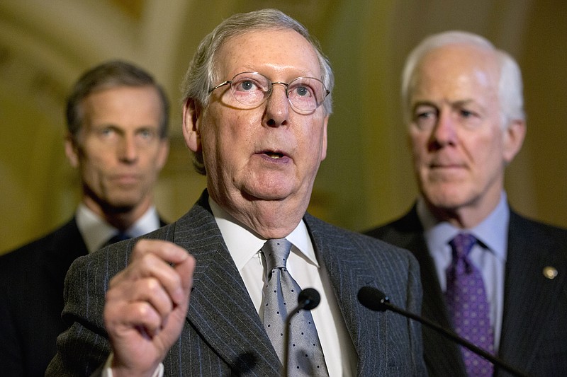 Senate Majority Leader Mitch McConnell of Ky., center, accompanied by Sen. John Thune, R-S.D., left, and Senate Majority Whip John Cornyn of Texas, speak during a news conference on Capitol Hill in Washington, Tuesday, Nov. 17, 2015, about events in Paris and refugees. 
