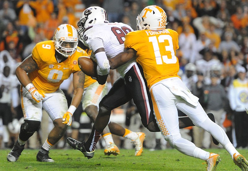 Tennessee defensive back Malik Foreman (13) forces a fumble by South Carolina tight end Jerell Adams (89) to clinch Tennessee's 27-24 win at an NCAA college football game in Knoxville, Tenn. on Saturday, Nov. 7, 2015. (Adam Lau/Knoxville News Sentinel via AP)
