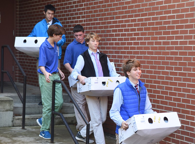McCallie students Michael Brown, Thomas Sell, Adam Smith, Denver Oliver and Victor Cheng, from right, carry boxes of turkeys to the Salvation Army truck at McCallie Thursday, November 19, 2015. McCallie Middle School and Upper Schools collected Thanksgiving food items for local families.