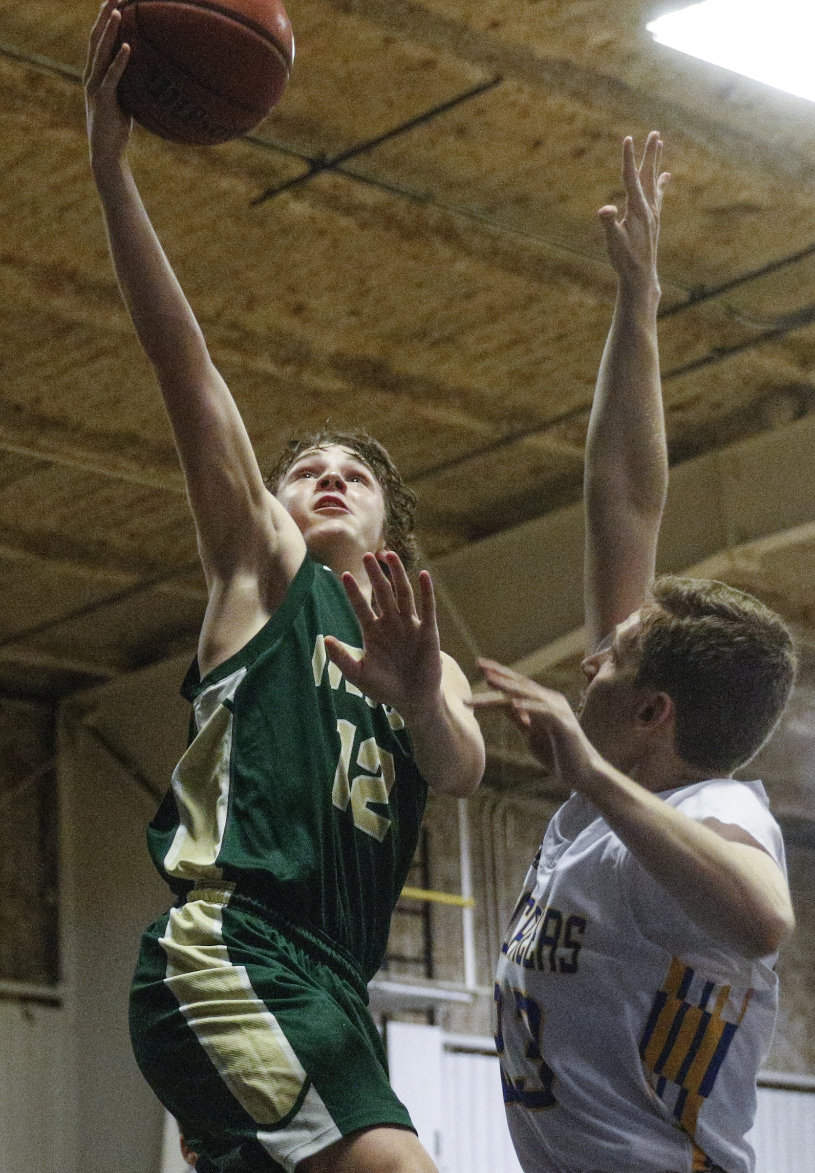 Notre Dame's Nolan Corbitt, left, shoots over Boyd-Buchanan's Andy Baumberger during their prep basketball game at Boyd-Buchanan High School on Thursday, Nov. 19, 2015, in Chattanooga, Tenn.