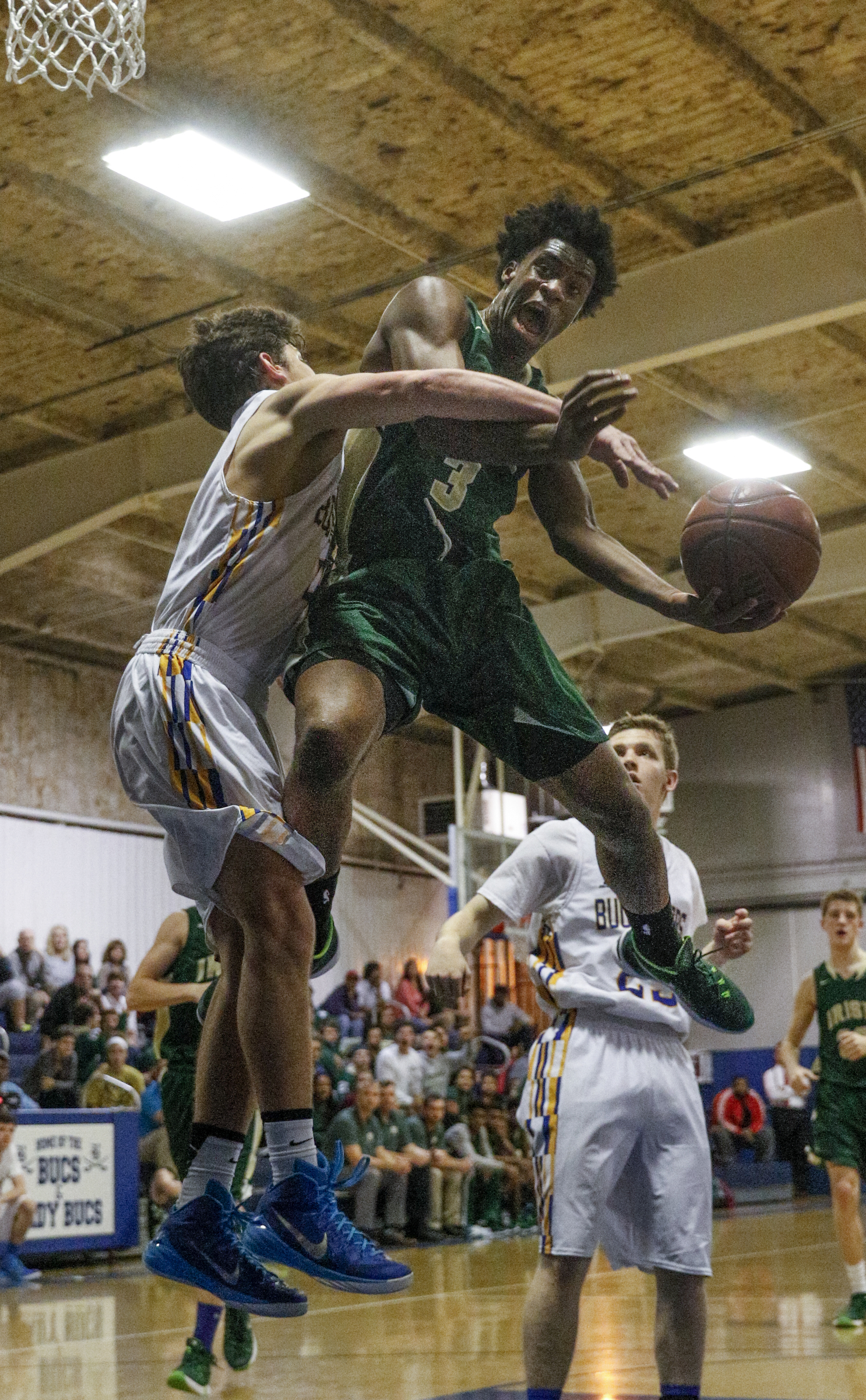 Notre Dame's Tyler Byrd, right, draws the foul from Boyd-Buchanan's Max Walker during their prep basketball game at Boyd-Buchanan High School on Thursday, Nov. 19, 2015, in Chattanooga, Tenn.