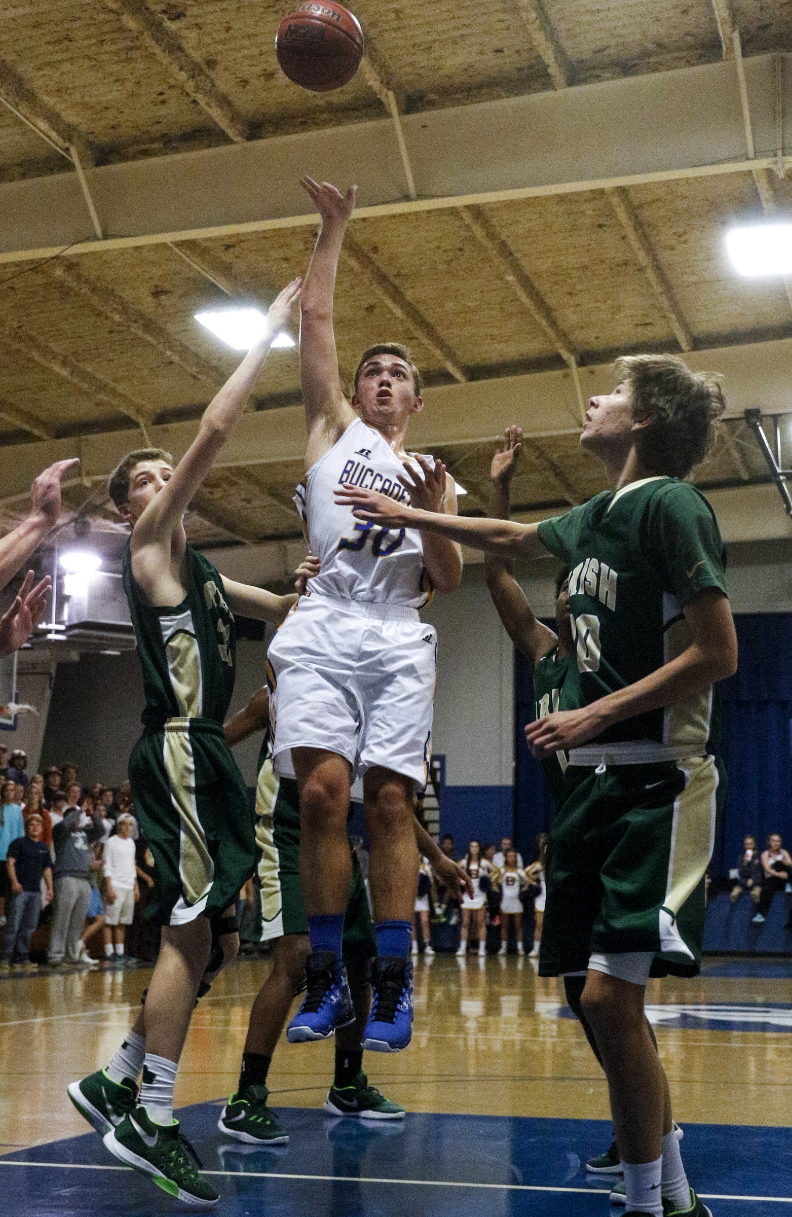 Boyd-Buchanan's Seth Rogers shoots flanked by Notre Dame's Peter Berce, right, and Luke Hix, left, during their prep basketball game at Boyd-Buchanan High School on Thursday, Nov. 19, 2015, in Chattanooga, Tenn.