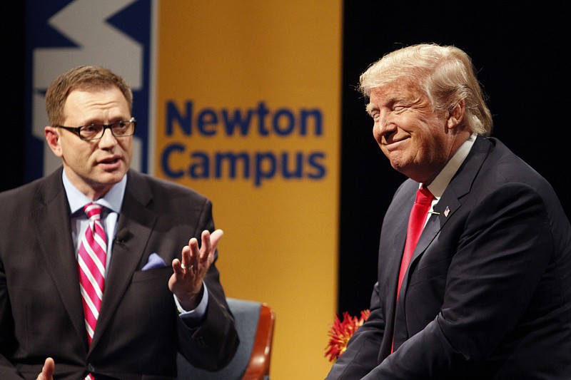 
              Republican presidential candidate Donald Trump laughs with host Dave Price during the WHO-HD Iowa Forums at the Des Moines Area Community College Newton Campus, Thursday, Nov. 19, 2015, in Newton, Iowa. (AP Photo/Matthew Holst)
            