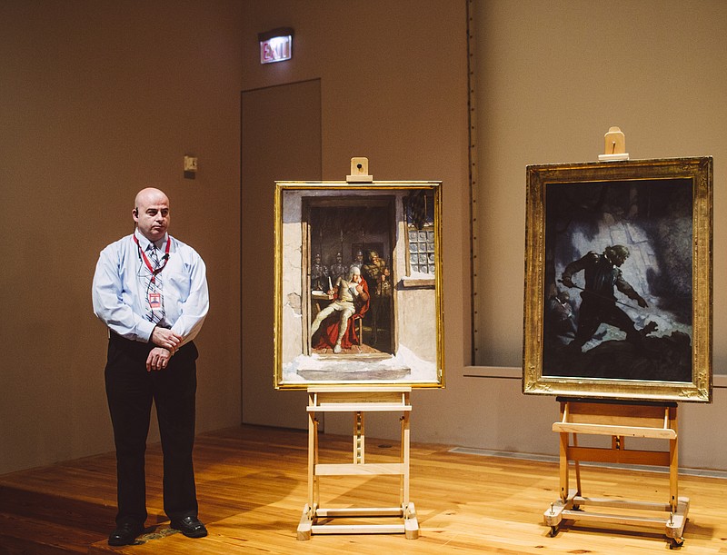 
              Portland Museum of Art security officer Shawn Higgins, left, stands next to two N.C. Wyeth paintings, "Go Dutton, and that right speedily," left, and "The Encounter on Freshwater Cliff" during the Press conference regarding the return of paintings to the museum, Thursday, Nov. 19, 2015, in Portland, Maine. The two paintings were recovered last month when a third party surrendered them to a retired FBI agent in the Boston area. (Whitney Hayward/Portland Press Herald via AP) MANDATORY CREDIT
            