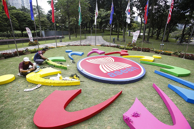 
              Workers add final touches to the ASEAN logo at the 27th Association of Southeast Asian Nations (ASEAN) summit in Kuala Lumpur, Malaysia, Thursday, Nov. 19, 2015. The ASEAN summit and relating meeting are held in Malaysia on Nov. 18-22. (AP Photo/Joshua Paul)
            
