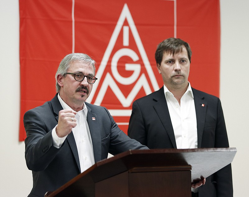 
              Wolfgang Lemb, left, of the German trade union IG Metall's executive board, speaks during a news conference Thursday, Nov. 19, 2015, in Spring Hill, Tenn. The United Auto Workers and German counterpart IG Metall will open a joint office to promote unionization among manufacturers and suppliers in the South. At right is Soeren Niemann-Findeisen, also of IG Metall. (AP Photo/Mark Humphrey)
            