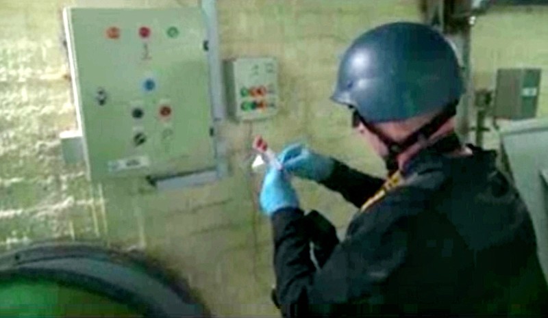 
              FILE - This file image made from video broadcast on Syrian State Television on Tuesday, Oct. 8, 2013, purports to show a chemical weapons expert taking samples at a chemical weapons plant at an unknown location in Syria. The Islamic State group is aggressively pursuing development of chemical weapons, setting up a branch dedicated to research and experiments with the help of scientists from Iraq, Syria and elsewhere in the region, according to Iraqi and U.S. intelligence officials. (Syrian State Television via AP video, File)
            