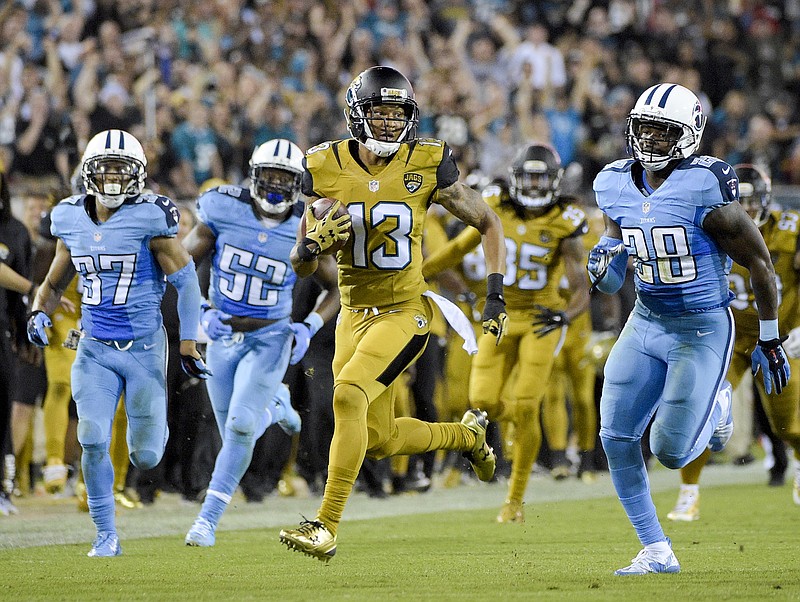 Jacksonville Jaguars' Rashad Greene runs back a punt return past Tennessee Titans cornerback Cody Riggs (37), Steven Johnson (52) and Marqueston Huff (28) during the second half of an NFL football game in Jacksonville, Fla., Thursday, Nov. 19, 2015.