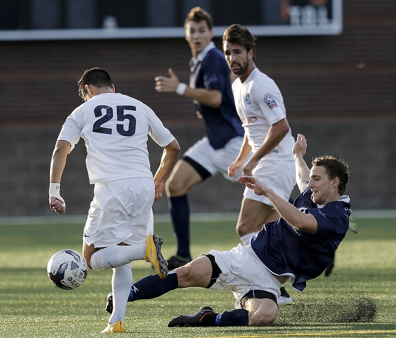 CFC's Wil Linder, right, clears the ball from Cosmos player Hagop Chirishian during Chattanooga FC's NPSL national championship match against the New York Cosmos at Finley Stadium on Saturday, Aug. 8, 2015, in Chattanooga, Tenn.