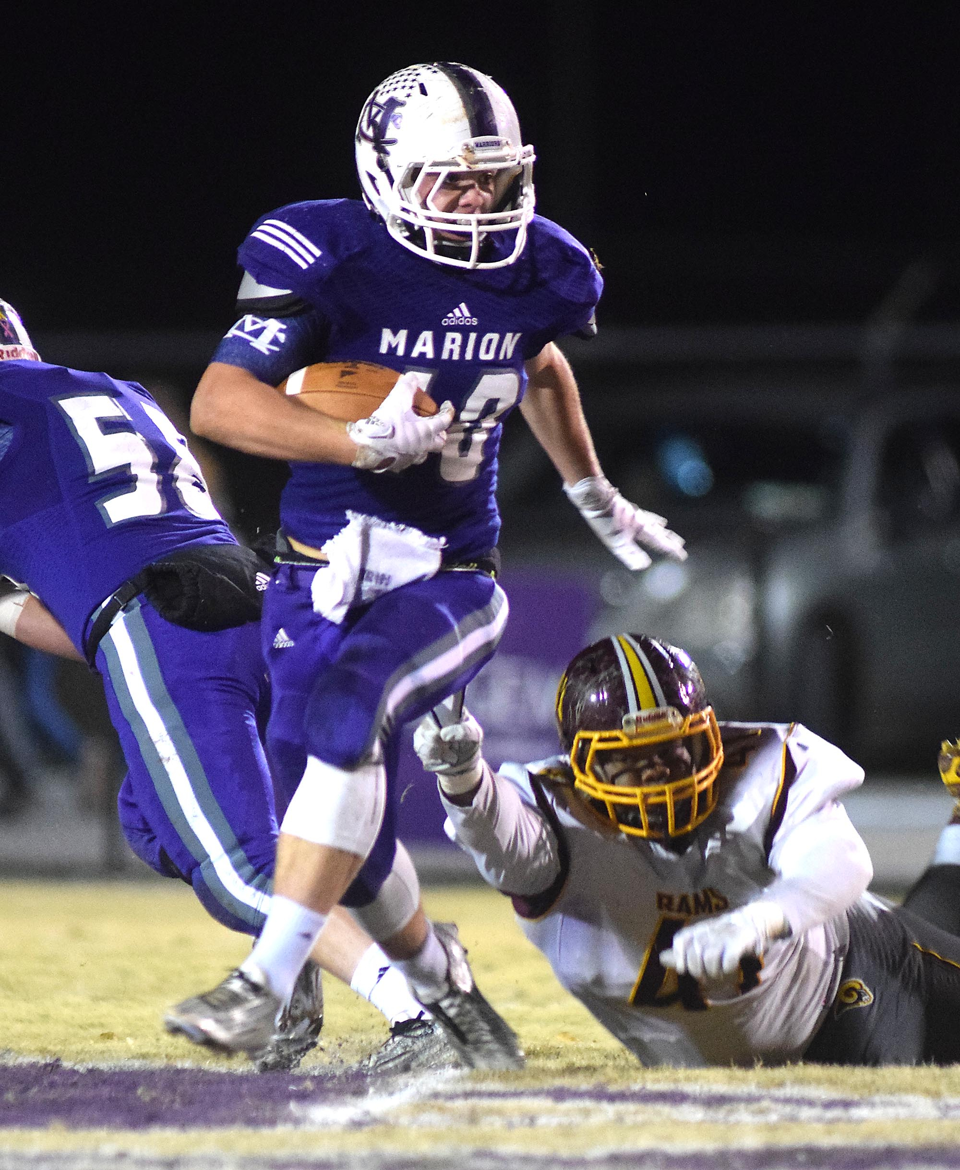 Marion County's Hunter McClain (40) escapes the grasp of Tyner's Kenrick Fuller (41). The Tyner Rams visited the Marion County Warriors in a quarterfinal game in the TSSAA State Football Playoffs on Friday November 20, 2015.