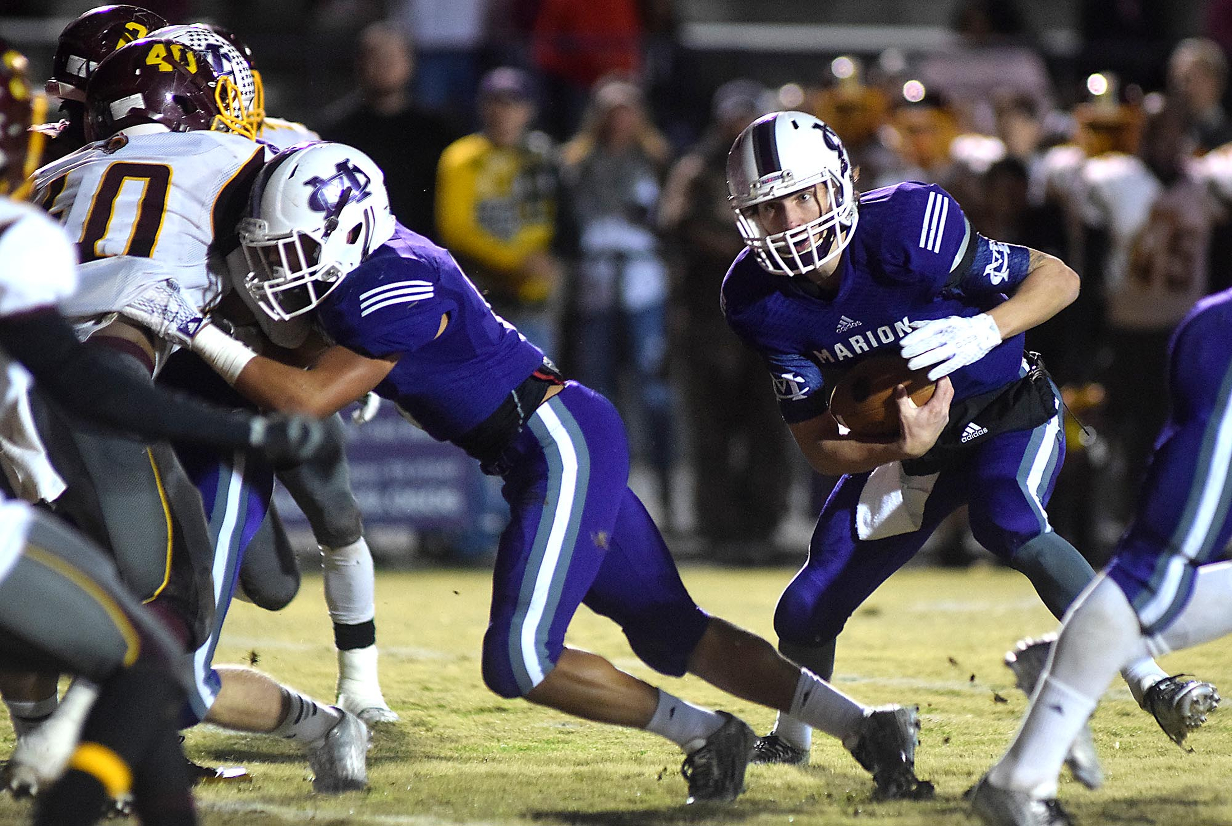 Marion County quarterback Logan Walters (1) looks for a hole in the Ram defense. The Tyner Rams visited the Marion County Warriors in a quarterfinal game in the TSSAA State Football Playoffs on Friday November 20, 2015.
