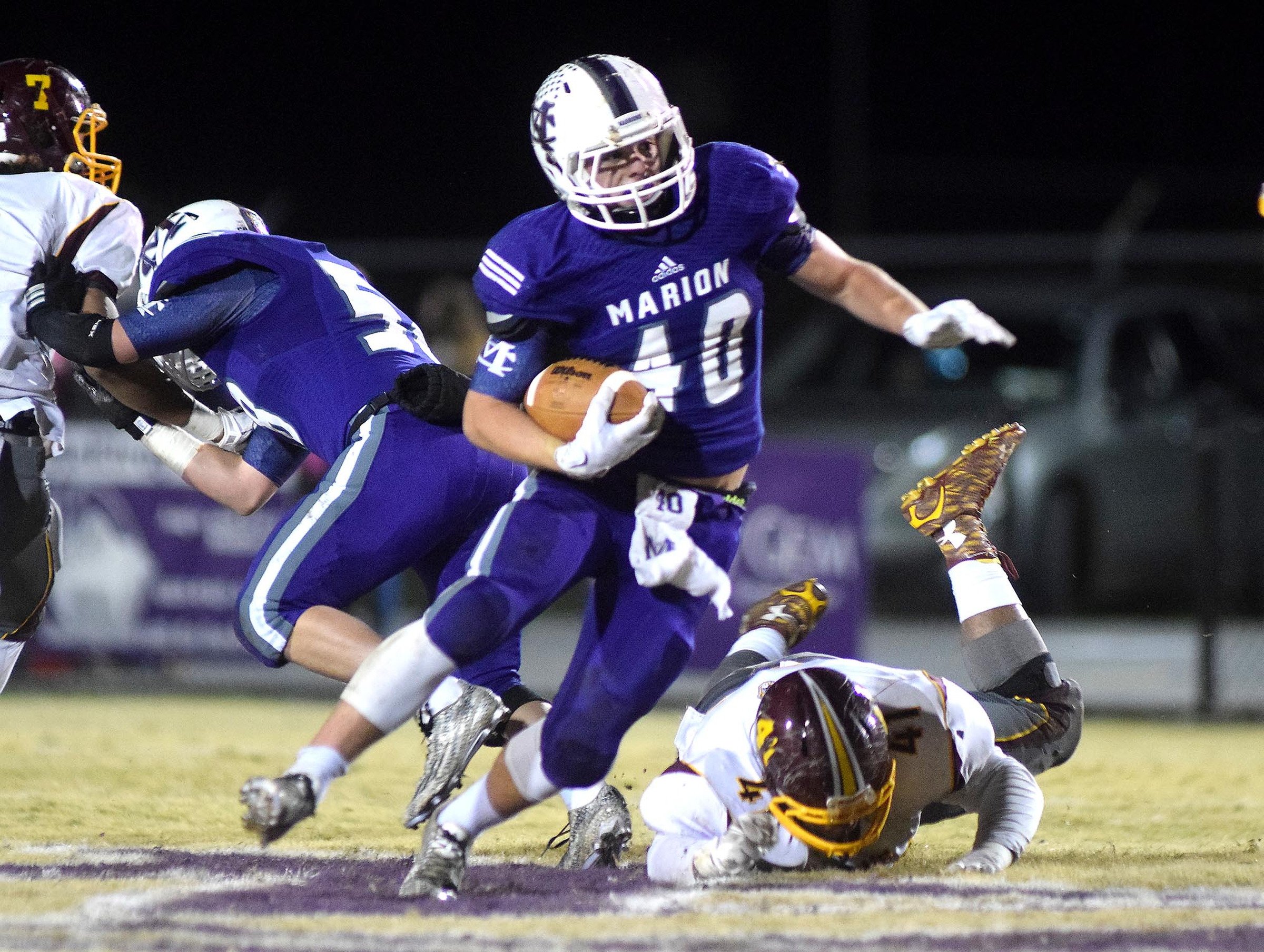 Marion County's Hunter McClain (4) breaks free for a second quarter Warrior gain. The Tyner Rams visited the Marion County Warriors in a quarterfinal game in the TSSAA State Football Playoffs on Friday November 20, 2015.