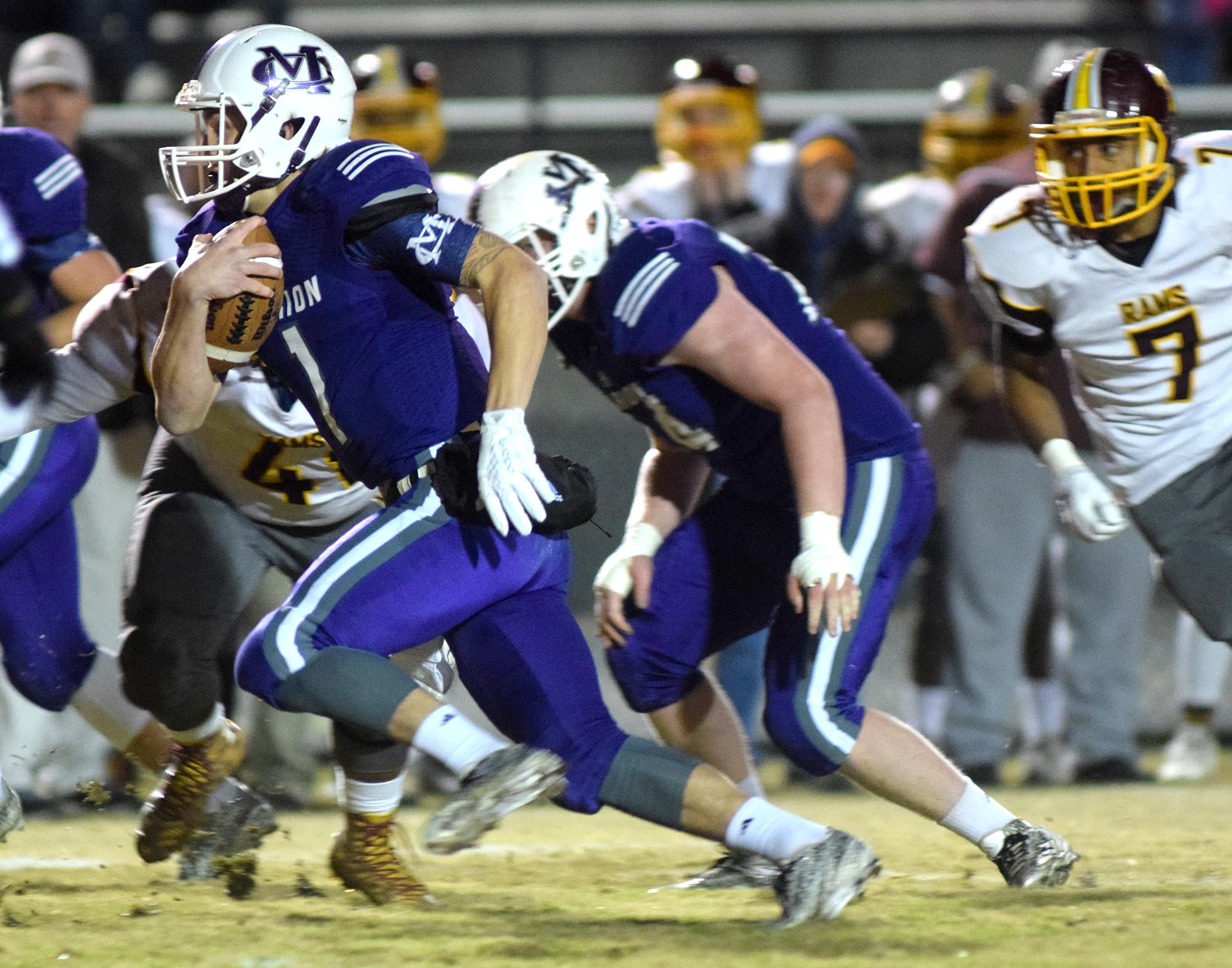 Marion County quarterback Logan Walters (1) breaks free for a big gain in the first quarter. The Tyner Rams visited the Marion County Warriors in a quarterfinal game in the TSSAA State Football Playoffs on Friday November 20, 2015.