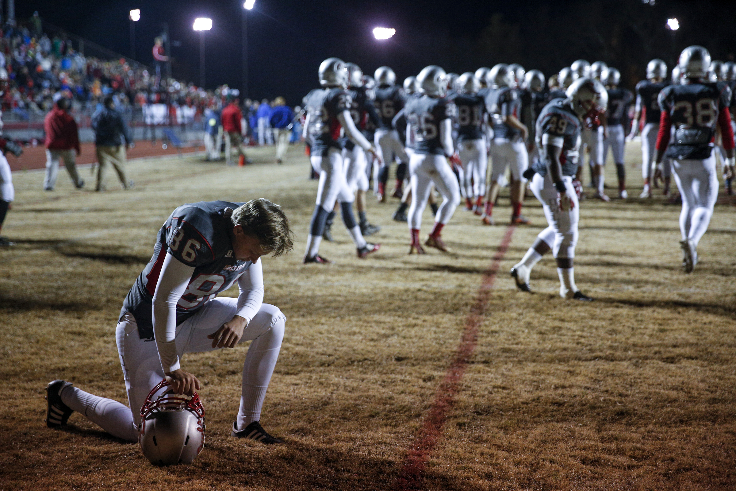 Ooltewah player Tyler Robertson pauses to pray as the team takes the field for their TSSAA prep football playoff football game against Rhea County at Ooltewah High School on Friday, Nov. 20, 2015, in Ooltewah, Tenn.