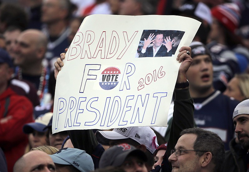 
              FILE - In this Oct. 25, 2015 file photo, a New England Patriots fan holds a sign that supports Patriots quarterback Tom Brady for president during an NFL football game against the New York Jets in Foxborough, Mass. GQ magazine asked Brady, its 2015 Man of the Year, if he’s ever considered making a play for the White House or at least for governor of Massachusetts. Brady said. "There is a 0.000 chance of me ever wanting to do that." (AP Photo/Steven Senne, File)
            