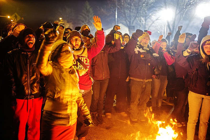 
              At the 4th Precinct in North Minneapolis, protesters demanded answers over the death of Jamar Clark who was shot and killed by police. Civil rights leaders appealed Thursday, Nov. 19, 2015, for Minneapolis police to exercise restraint but the head of the police union said officers should get tougher with protesters after a night of tense confrontations over the fatal shooting of a black man by an officer.  (Richard Tsong-Taatarii/Star Tribune via AP)
            