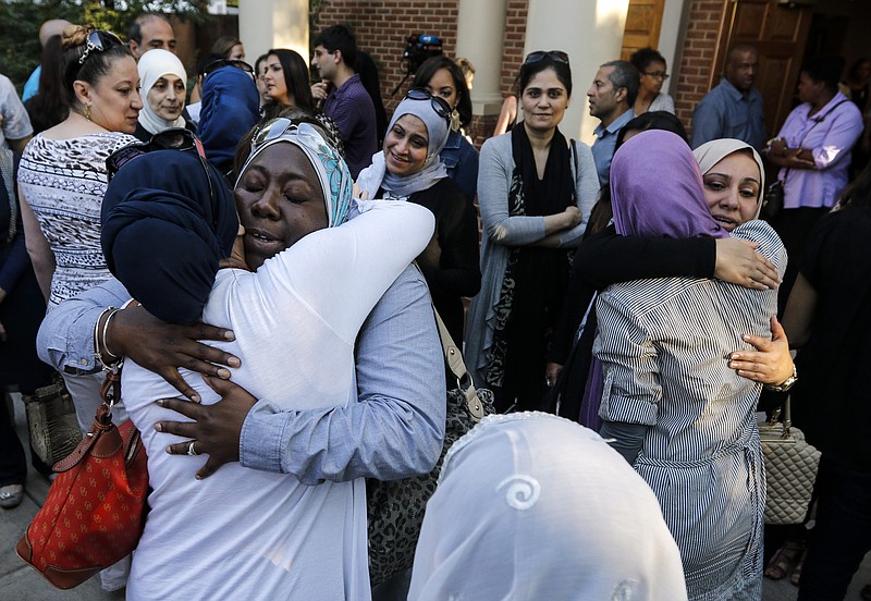 Women who came with others from the Islamic Society of Greater Chattanooga to offer their support hug outside after an interfaith vigil at Olivet Baptist Church held in remembrance of victims of the July, 16 shootings on Friday, July 17, 2015, in Chattanooga, Tenn. The vigil was held one day after gunman Mohammad Youssef Abdulazeez shot and killed four U.S. Marines and wounded two others and a Chattanooga police officer at the Naval Operational Support Center on Amnicola Highway shortly after firing into the Armed Forces Career Center on Lee Highway.