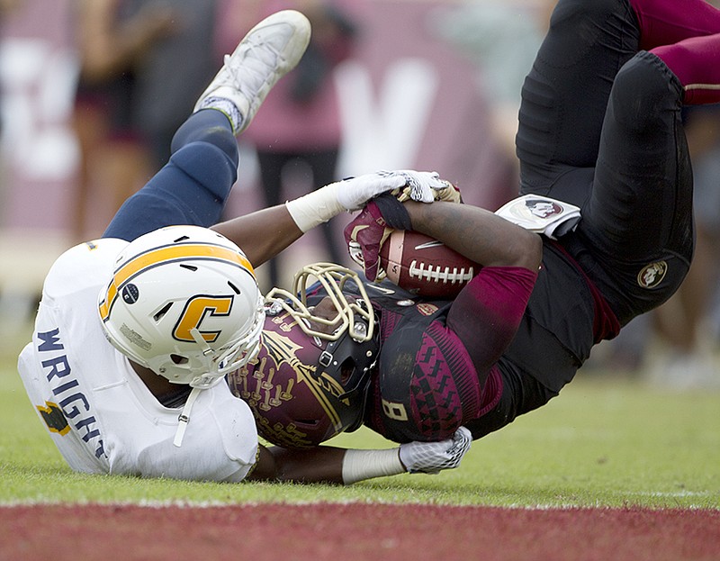 Florida State's Kermit Whitfield comes down with a 33-yard reception at the 1-yard line against Chattanooga's Trevor Wright during the first half of an NCAA college football game in Tallahassee, Fla., Saturday, Nov. 21, 2015.  (AP Photo/Mark Wallheiser)