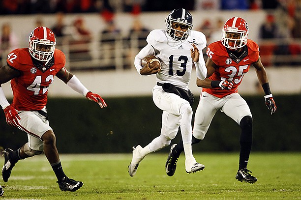 Georgia Southern quarterback Favian Upshaw (13) breaks away from Georgia cornerback Aaron Davis (35) Georgia linebacker Tim Kimbrough (42) as he runs for a first down in the first half of an NCAA college football game Saturday, Nov. 21, 2015, in Athens, Ga. (AP Photo/John Bazemore)