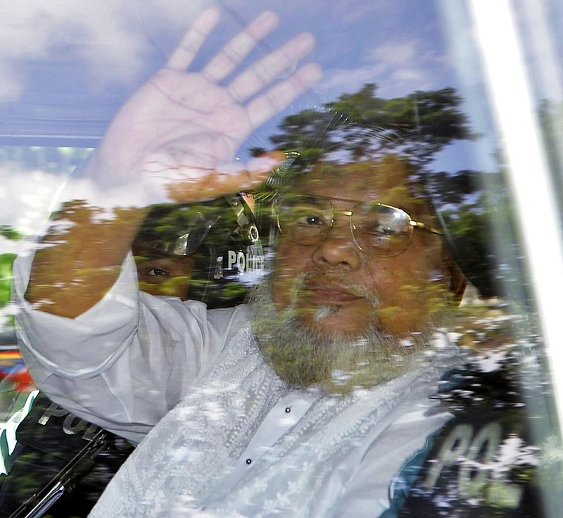 
              FILE - In this July 17, 2013, file photo, Jamaat-e-Islami Secretary General Ali Ahsan Mohammad Mujahid waves from a police vehicle as he is brought to court in Dhaka, Bangladesh. Senior Jail Superintendent Mohammad Jahangir Kabir told The Associated Press early Sunday, Nov. 22, 2015, that Bangladesh Nationalist Party leader Salahuddin Quader Chowdhury and Ali Ahsan Mohammad Mujahid were executed, for committing war crimes during the country's 1971 independence war against Pakistan, at Dhaka Central Jail in the nation's capital. (AP Photo, File)
            