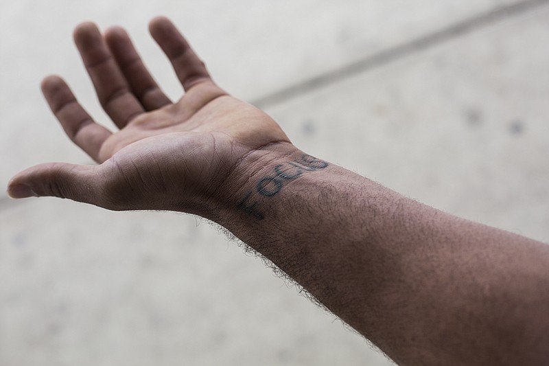 
              This photo taken Oct. 28, 2015, shows DuPree Lytle's wrist that had the word “Focus’’ tattooed near scars on his left wrist that were left by the handcuffs while being arrested. “It changed a lot of DuPree’s life. He has lost focus. And he’s trying to get it back,” Carla Lytle, DuPree’s mother, said about her son and how he’s changed after that night. (Brad Vest/The Commercial Appeal via AP)
            