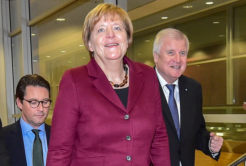 
              German chancellor Angela Merkel, center, arrives  at a party convention of the Christian Social Union party, CSU, Bavarian only sister party of Merkel's Christian Democrats,  accompanied by Bavarian governor Horst Seehofer, right,  and CSU Secretary general, Andreas Scheuer , in Munich, southern Germany, Friday Nov. 20, 2015. .( Peter Kneffel/dpa via AP)
            