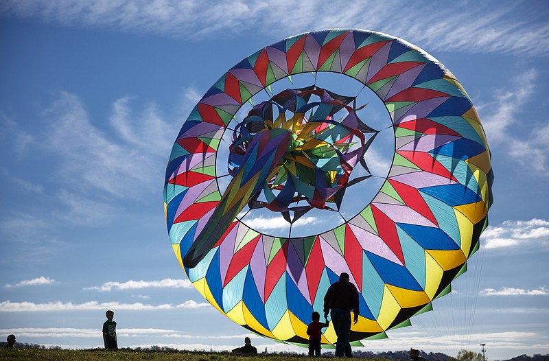 People watch a Sweeney bol kite which is anchored to the ground at a demonstration by the Chattanooga Kite Club at the Sculpture Fields park on Polk Street on Saturday, Nov. 21, 2015, in Chattanooga. Many of the kites displayed at the demonstration were created by local master kite maker Martin Blais.