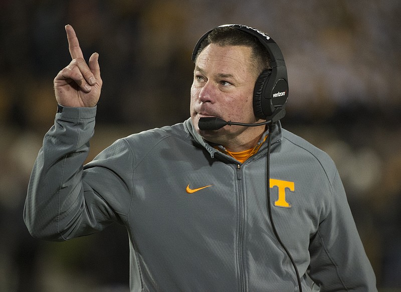 Tennessee head coach Butch Jones points to the scoreboard during the first quarter of an NCAA college football game against Missouri Saturday, Nov. 21, 2015, in Columbia, Mo. Tennessee won the game 19-8. (AP Photo/L.G. Patterson)