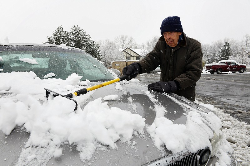 
              Ed Podrasky clears snow off his car as he gets ready to go to the store Saturday, Nov. 21, 2015, in Arlington Heights, Ill. The first significant snowstorm of the season blanketed some parts of the Midwest with more than a foot of snow and more was on the way Saturday, creating hazardous travel conditions and flight delays. (Joe Lewnard/Daily Herald via AP) MANDATORY CREDIT; MAGS OUT
            