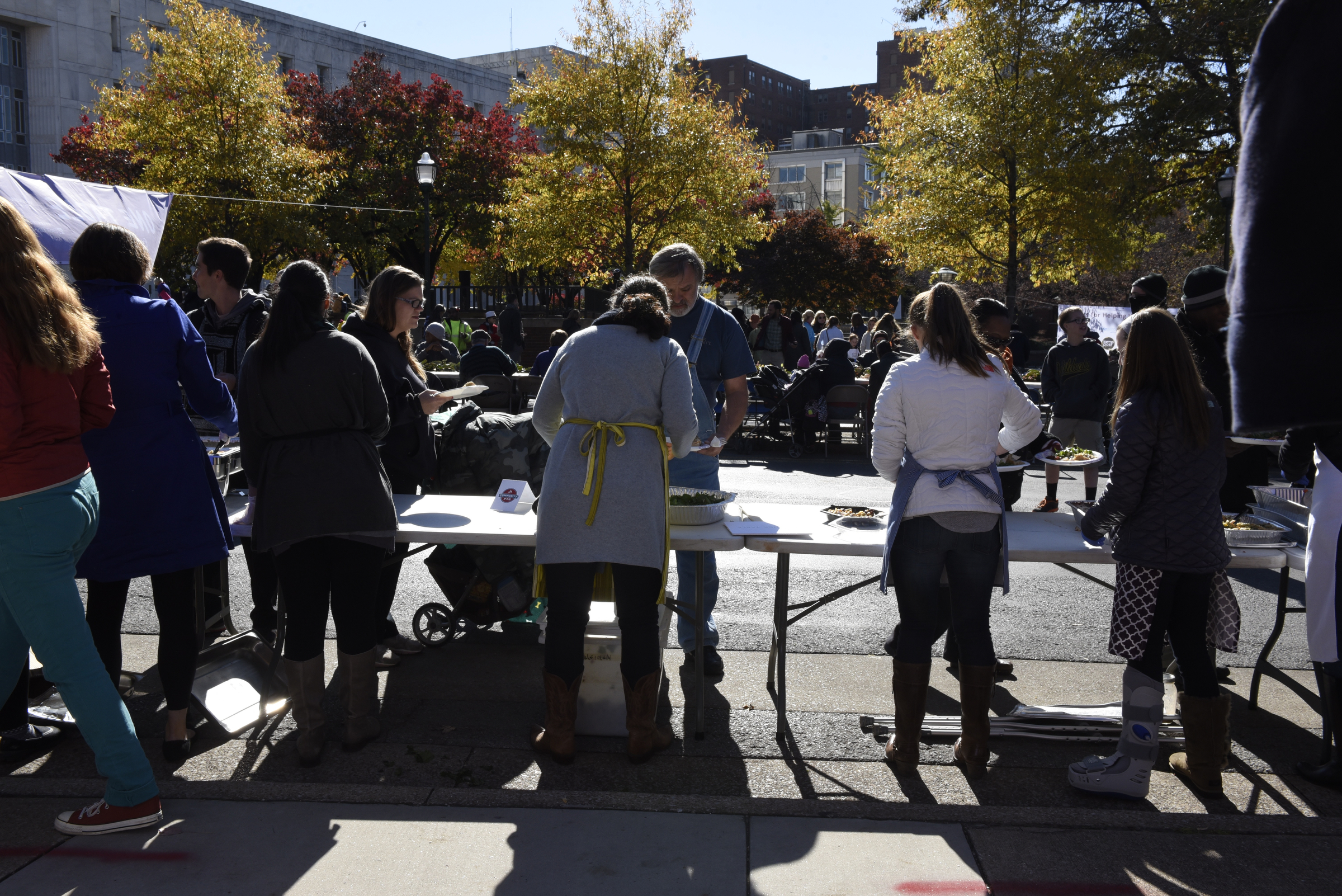 Volunteers serve food during the second annual One Table event Monday, Nov. 23, 2015, in Chattanooga, Tenn. The event features a Thanksgiving meal available to anyone, and is served on long table in the middle of ML King Boulevard in between Miller Park and Miller Plaza.