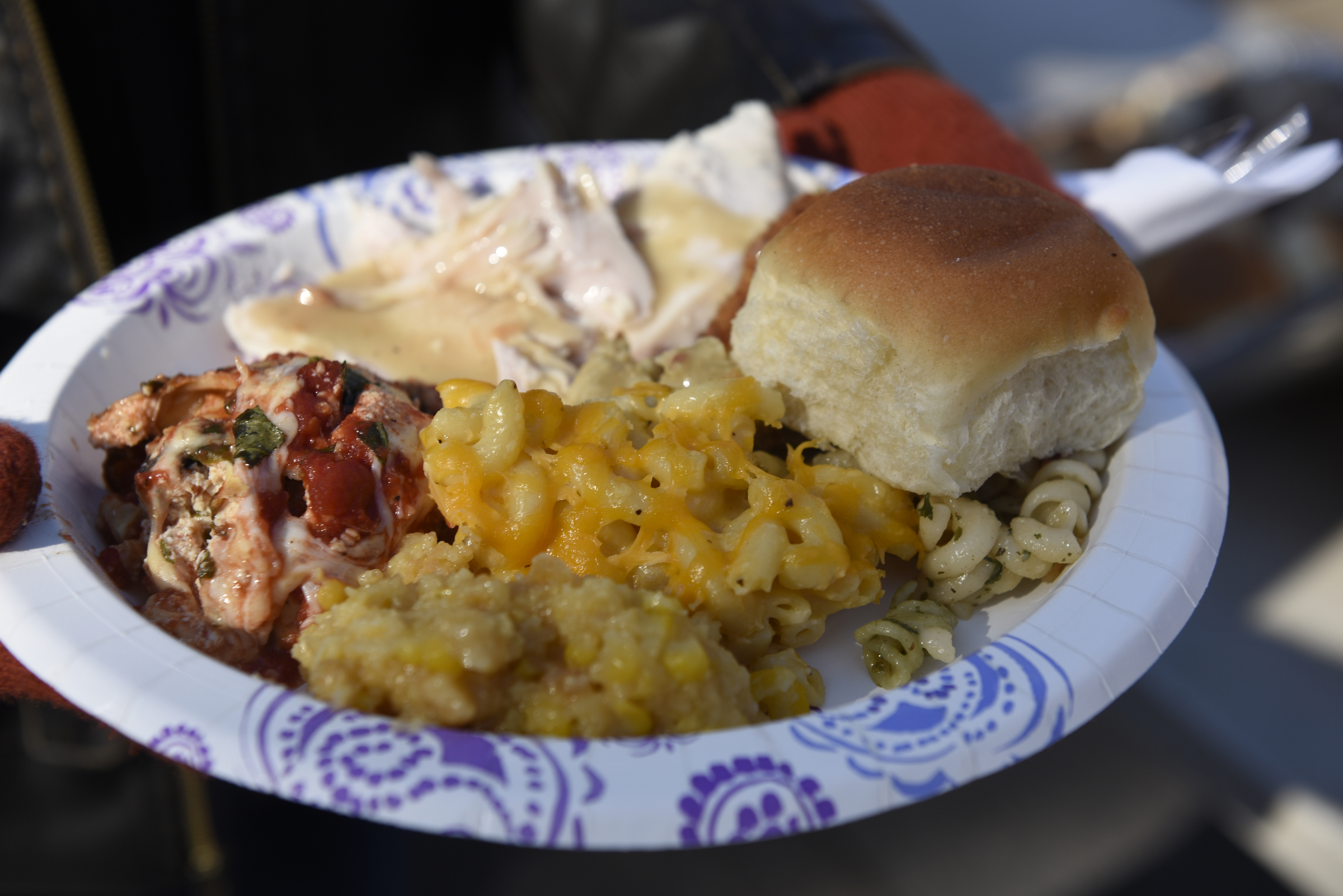 A participant shows his plate of food during the second annual One Table event Monday, Nov. 23, 2015, in Chattanooga, Tenn. The event features a Thanksgiving meal available to anyone, and is served on long table in the middle of ML King Boulevard in between Miller Park and Miller Plaza.
