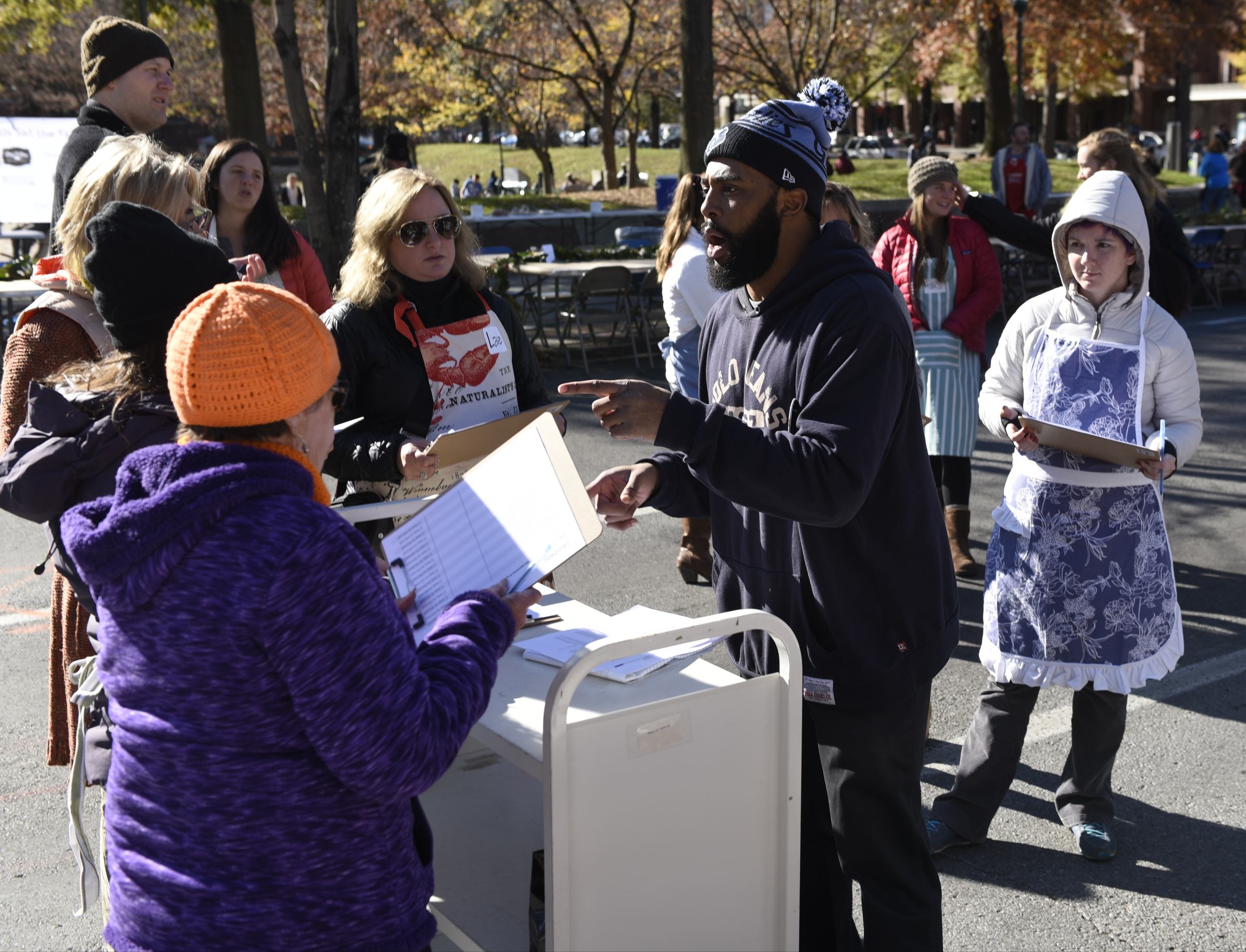 James Chapman organizes volunteer workers prior to the second annual One Table event Monday, Nov. 23, 2015, in Chattanooga, Tenn. The event features a Thanksgiving meal available to anyone, and is served on long table in the middle of ML King Boulevard in between Miller Park and Miller Plaza.