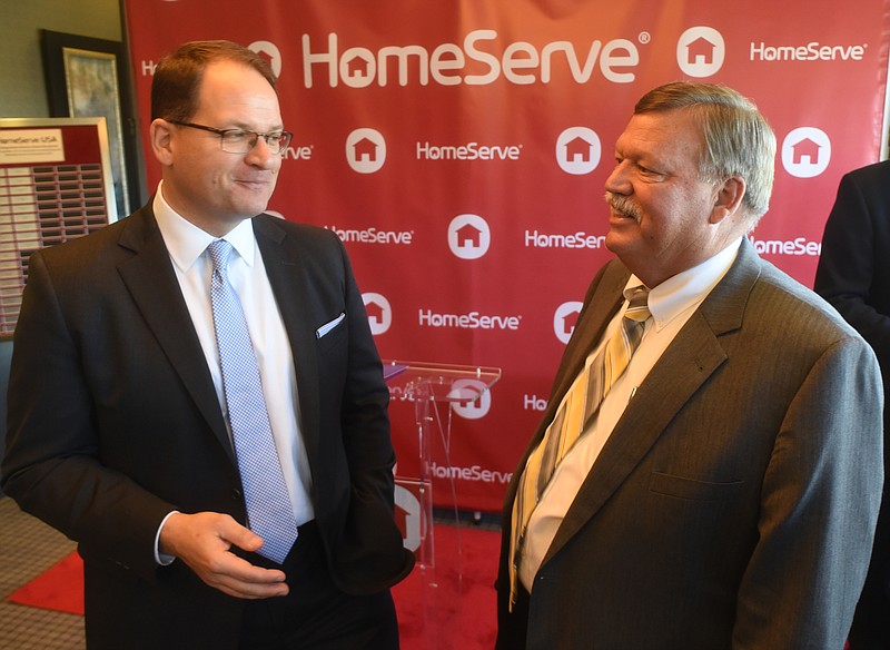 HomeServe CEO  Tom Rusin, left, speaks with Hamilton County Mayor Jim Coppinger Friday, November 20, 2015 during a celebration of the company's fifth anniversary.