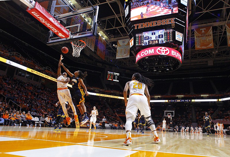 Tennessee guard Diamond DeShields (11) shoots past Chattanooga guard Shelbie Davenport (22) in the first half of an NCAA college basketball game Monday, Nov. 23, 2015, in Knoxville.