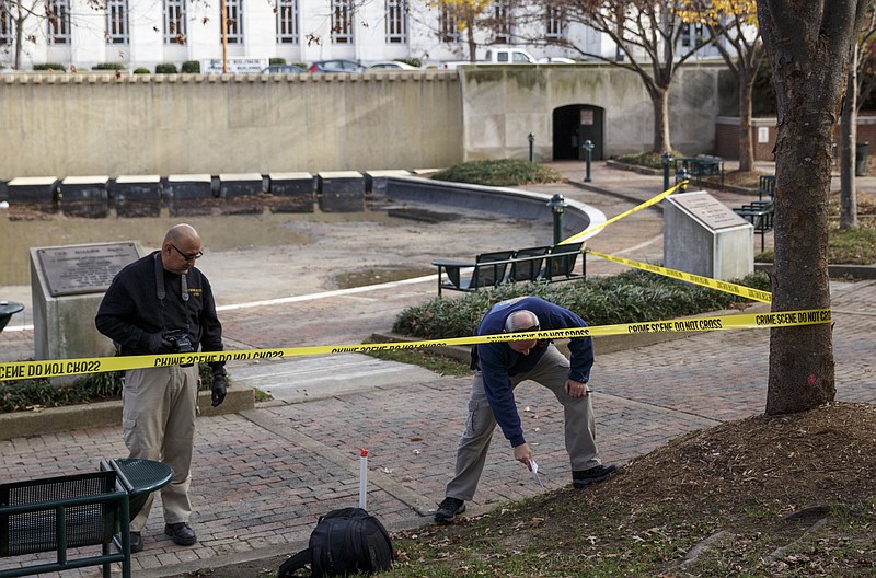 Investigators with the Crime Scene Unit work the scene of an early afternoon shooting in Miller Park on Tuesday, Nov. 24, 2015, in Chattanooga. Chattanooga Police said that around noon, an unnamed man was shot twice and taken to an area hospital in non-life-threatening condition, and a male suspect was taken into custody.