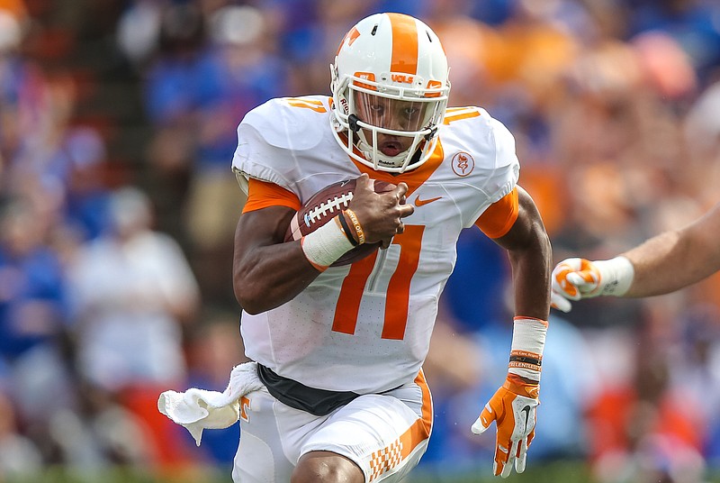 Tennessee quarterback Joshua Dobbs (11) runs the ball for a touchdown after a catch against Florida during the first half in an NCAA college football game, Saturday, Sept. 26, 2015 in Gainesville, Fla. (AP Photo/Gary McCullough)