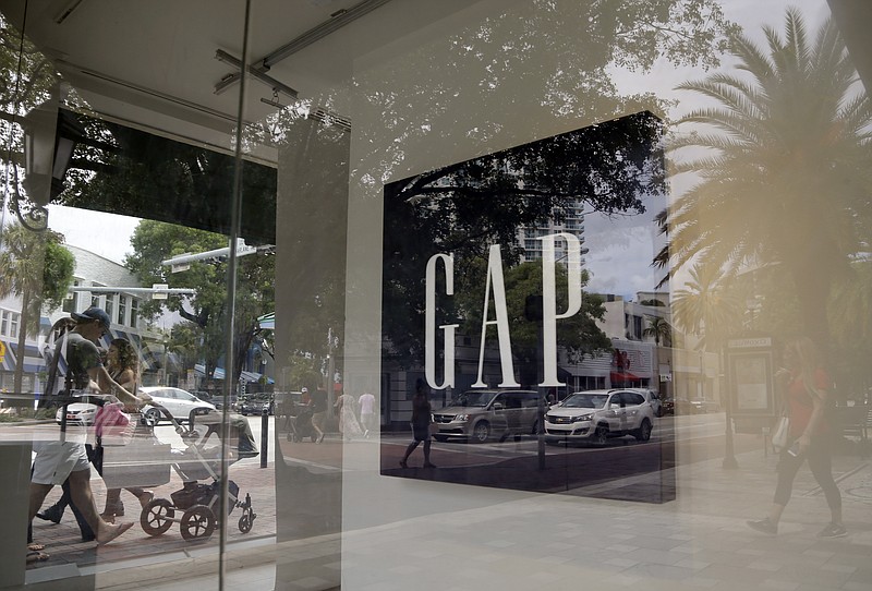 
              In this Saturday, Aug. 15, 2015, photo, pedestrians walks past a Gap store in Miami. The Commerce Department issues the second of three estimates on how the U.S. economy performed in the July-September quarter on Tuesday, Nov. 24, 2015. (AP Photo/Lynne Sladky)
            