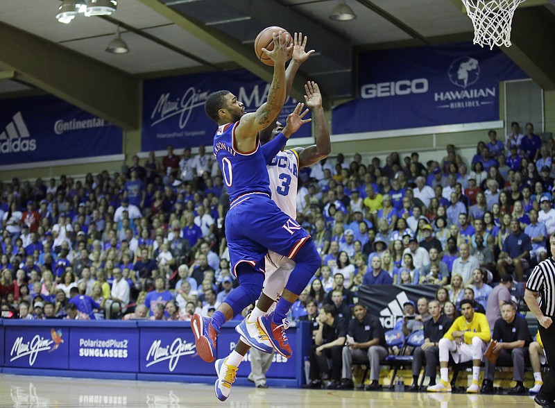 
              Kansas guard Frank Mason III (0) goes to the basket as UCLA guard Aaron Holiday (3) defends in the first half during an NCAA college basketball game in the second round of the Maui Invitational, Tuesday, Nov. 24, 2015, in Lahaina, Hawaii. (AP Photo/Rick Bowmer)
            
