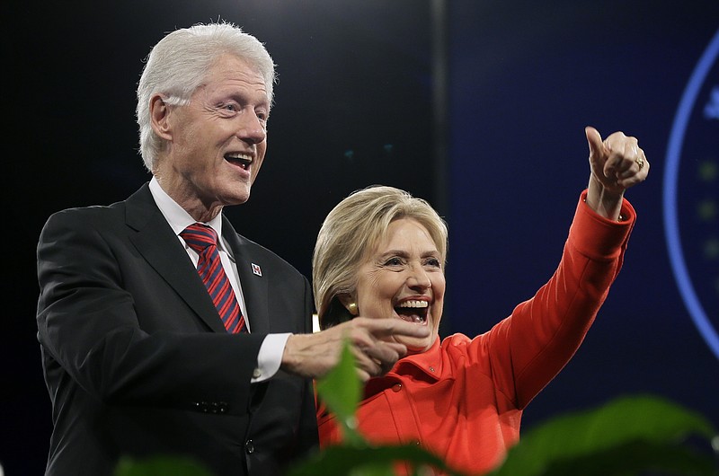 
              FILE - In this Oct. 24, 2015 file photo, former President Bill Clinton and his wife, Democratic presidential candidate Hillary Rodham Clinton, wave to supporters after the Iowa Democratic Party's Jefferson-Jackson fundraising dinner in Des Moines, Iowa. Clinton wants voters to know she is no friend of Wall Street. She and husband have made $35 million from 164 paid speeches to financial services, real estate and insurance companies since leaving the White House in 2001. (AP Photo/Charlie Neibergall, File)
            