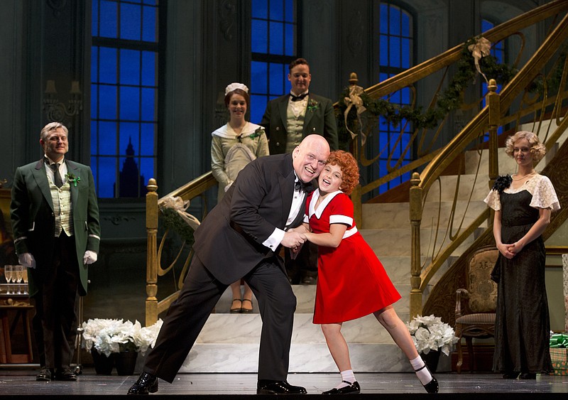 
              In this image released by Boneau/Bryan-Brown shows Gilgamesh Taggett as Oliver Warbucks, left, and Issie Swickle as Annie during a performance of the national tour of the musical "Annie." Based on the beloved comic strip that debuted in 1924, "Annie" first opened on Broadway in 1977 and ran for almost six years, fueled by songs including "It's the Hard-Knock Life" and "Tomorrow." (Joan Marcus/Boneau/Bryan-Brown via AP)
            