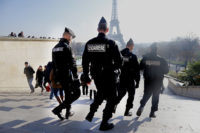 
              French gendarmes officers patrol near the Eiffel Tower, in Paris, Monday Nov. 23, 2015.  French President Francois Hollande will preside over a national ceremony on Nov. 27 honoring the at least 130 victims of the deadliest attacks on France in decades.  (AP Photo/Jacques Brinon)
            