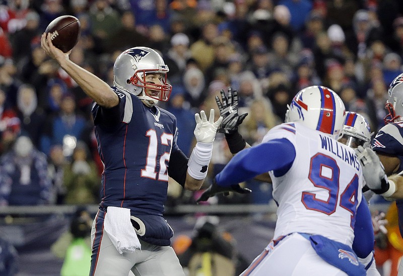 New England Patriots quarterback Tom Brady (12) passes over Buffalo Bills defensive end Mario Williams (94) in the first half of an NFL football game Monday, Nov. 23, 2015, in Foxborough, Mass.